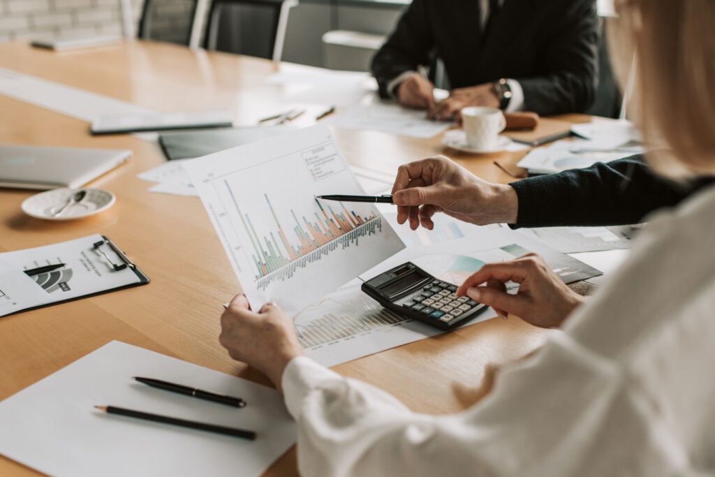 Besprechung mit Finanzgrafiken, Unterlagen und Taschenrechner